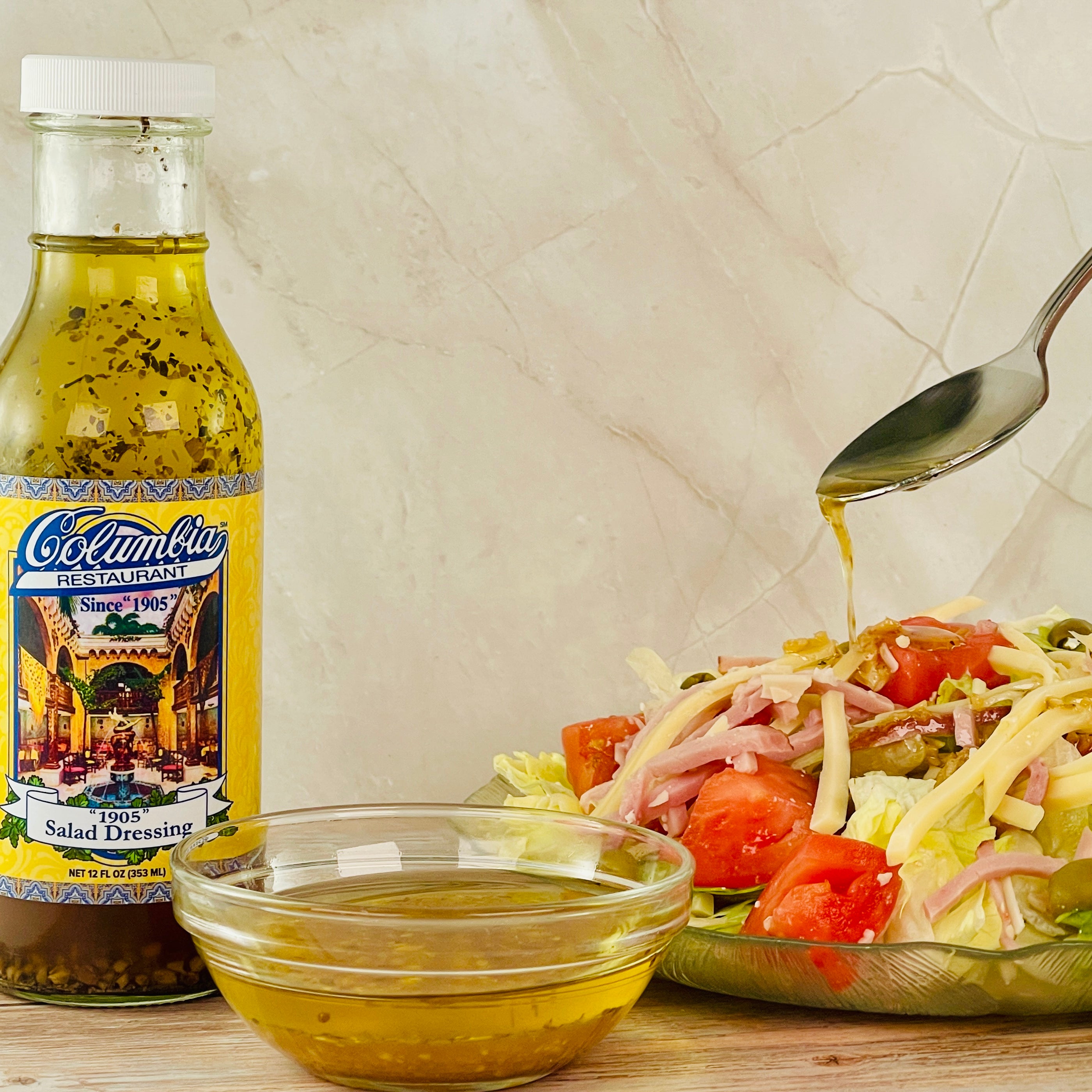 Klondike salad dressing bottle with a salad and dressing being poured on a wooden surface.