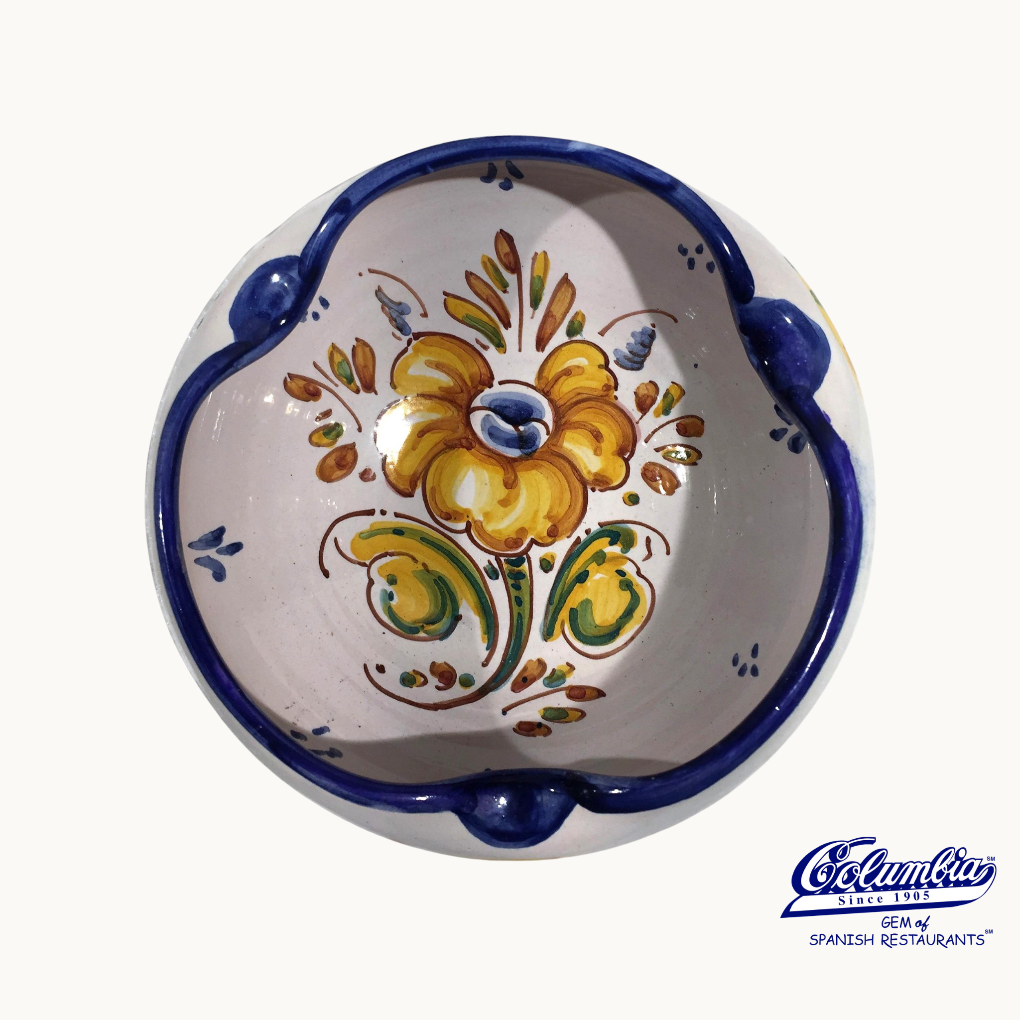 Ceramic bowl with floral design and blue rim on a white background