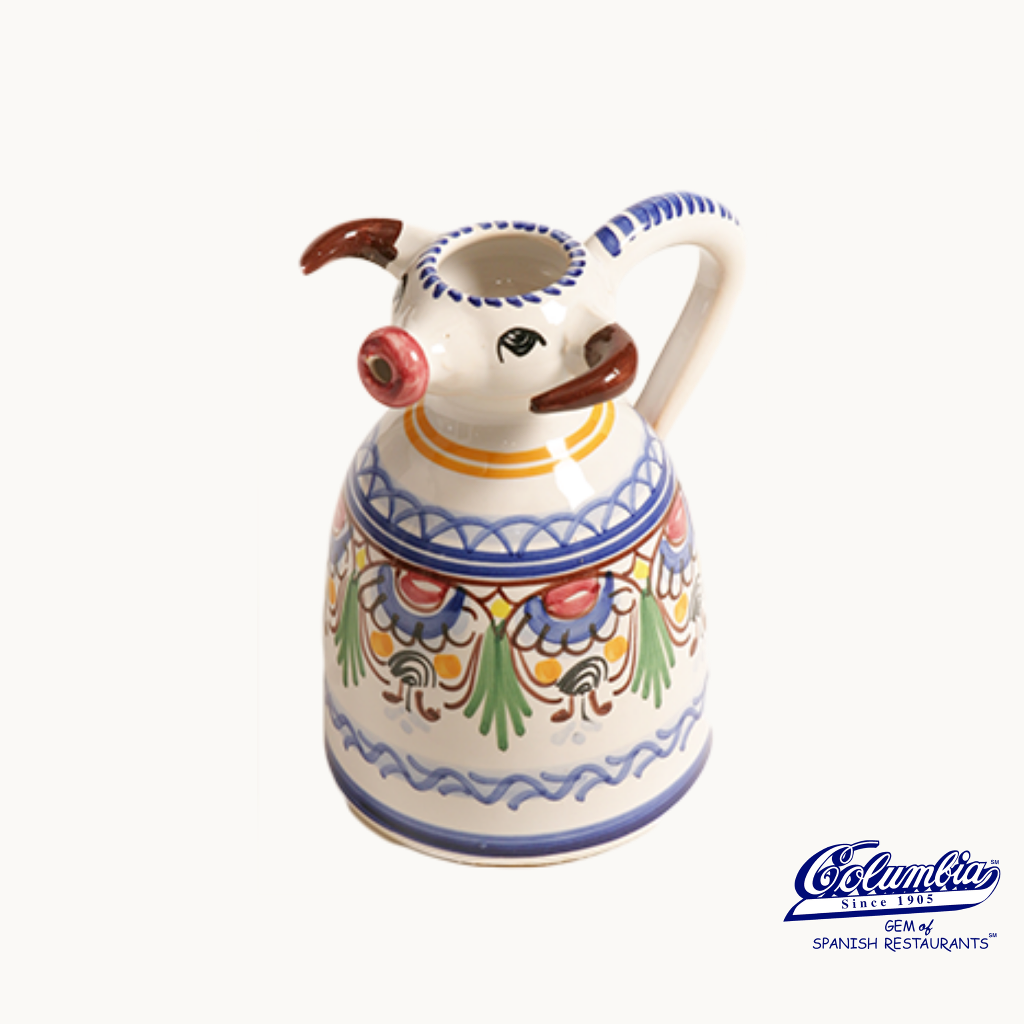 Ceramic pig-shaped pitcher with colorful patterns on a white background.