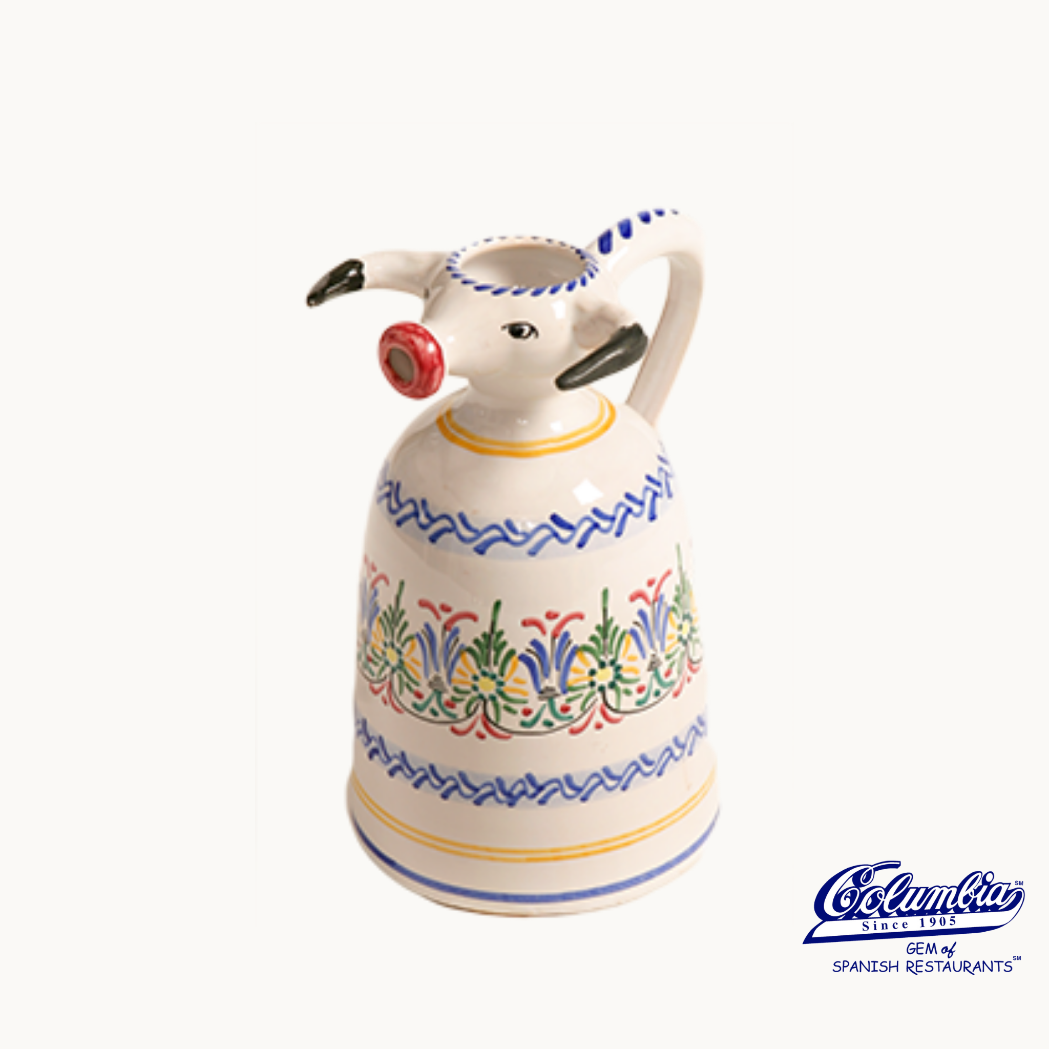 Decorative ceramic oil dispenser shaped like a cow on a white background.