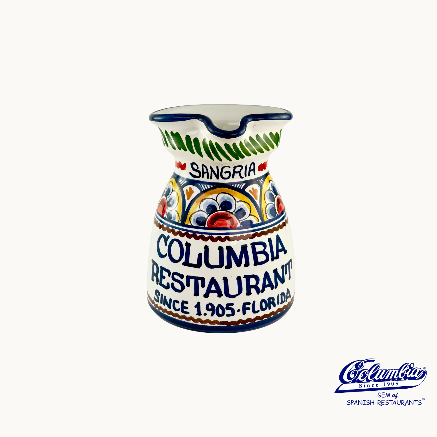 A ceramic pitcher with colorful hand-painted patterns, labeled 'SANGRIA' and 'COLUMBIA RESTAURANT'.