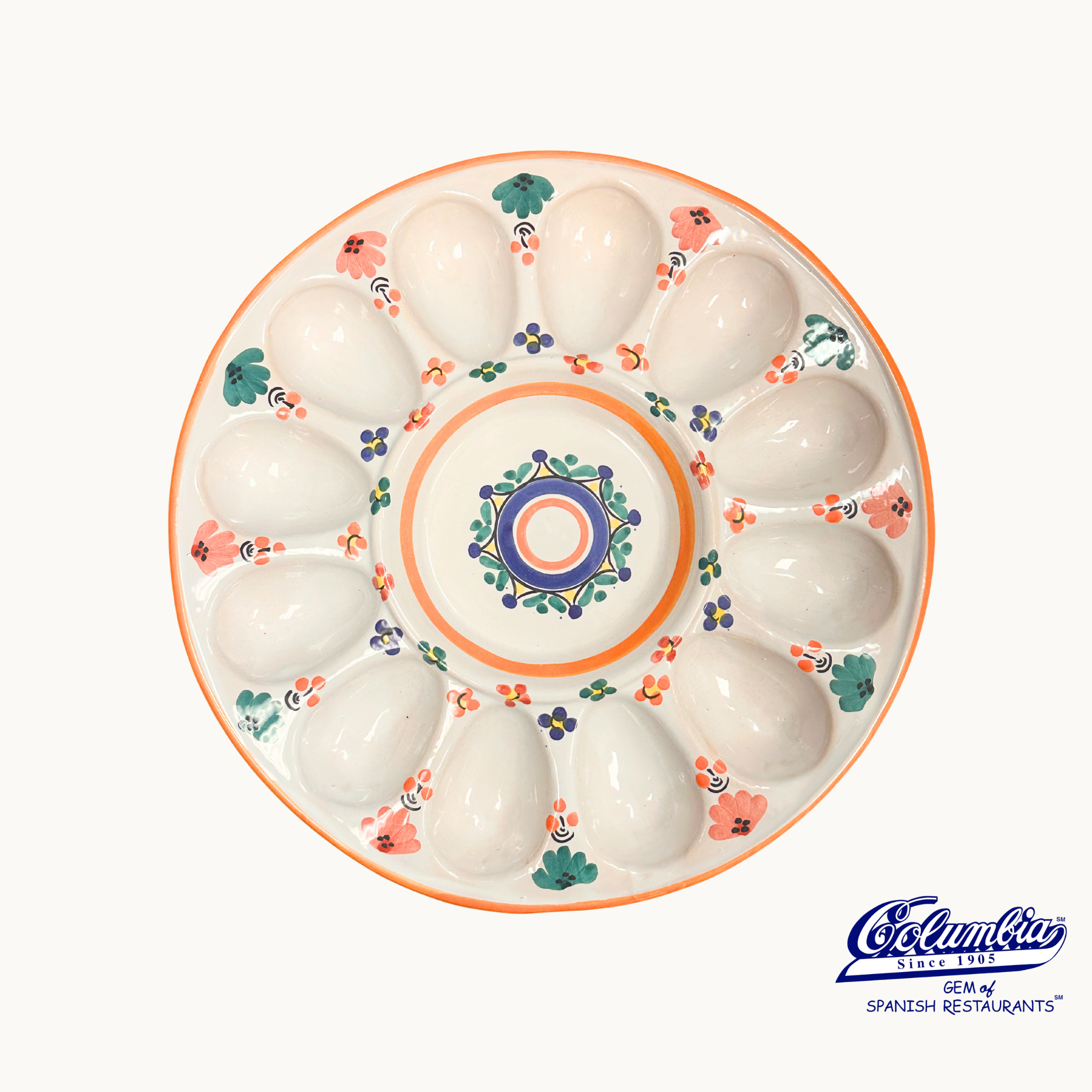 Decorative ceramic plate with floral patterns on a white background, featuring the Cocinilla logo.