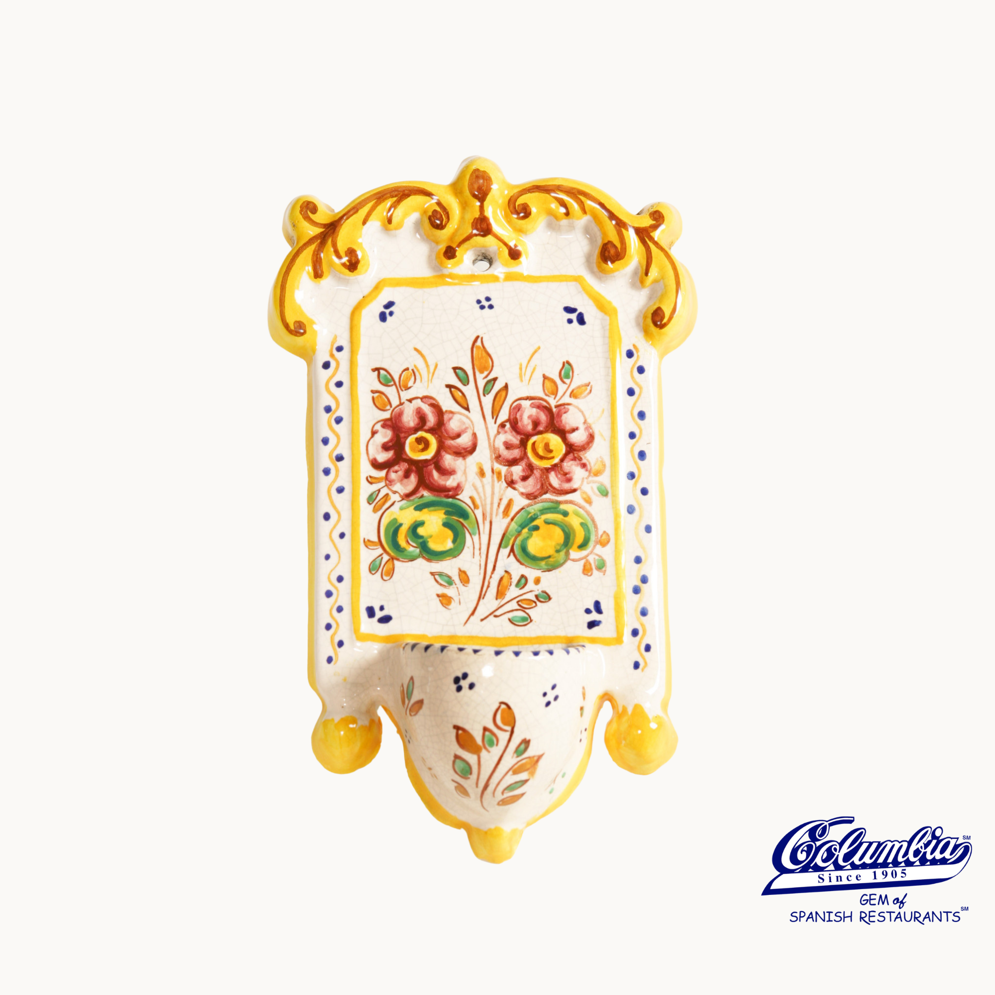 Decorative ceramic wall hanging with floral designs on a white background.
