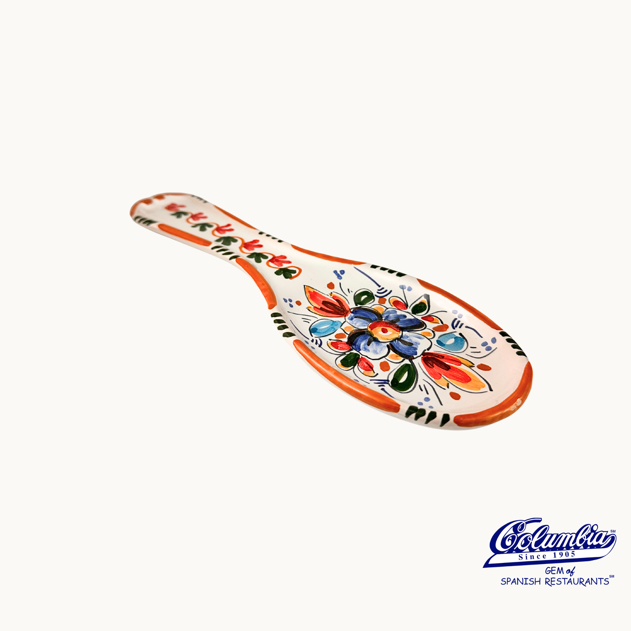 Ceramic spoon rest with colorful floral patterns on a white background