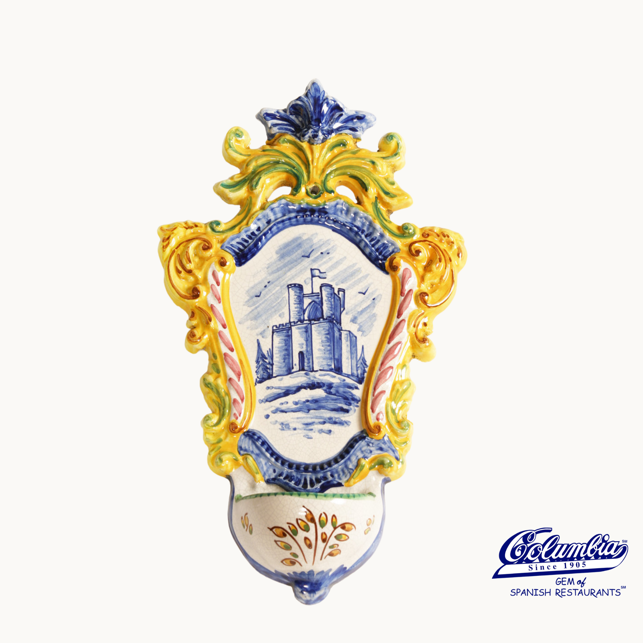 Decorative ceramic wall plaque with castle design and colorful ornate frame on white background.