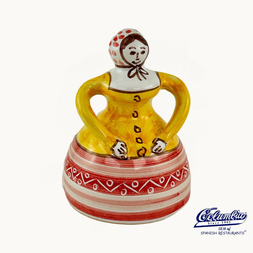 Ceramic figurine with a colorful dress on a white background, featuring the Columba brand.