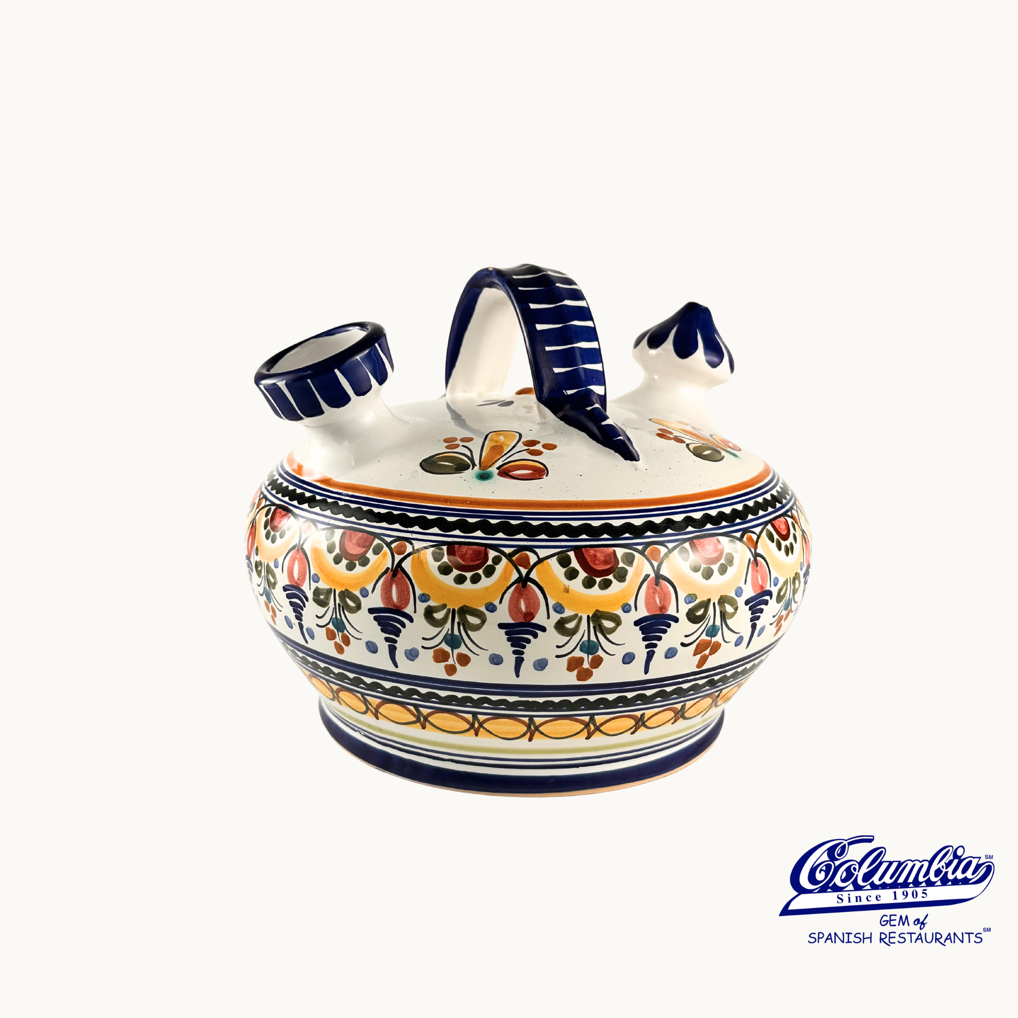Ceramic teapot with colorful floral patterns on a white background, featuring the Colmenar brand.