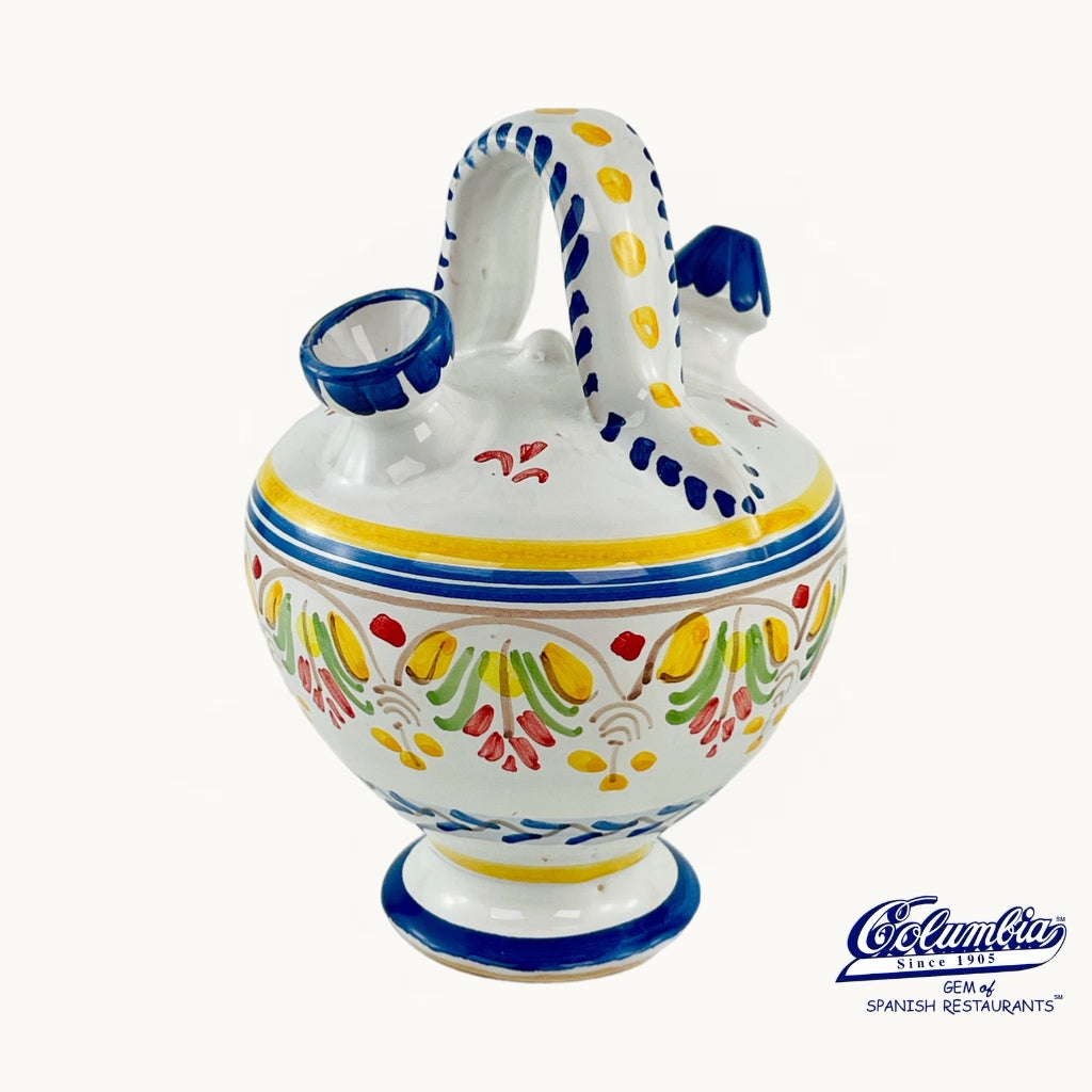 Decorative ceramic jar with colorful patterns on a white background, featuring the Columba logo.