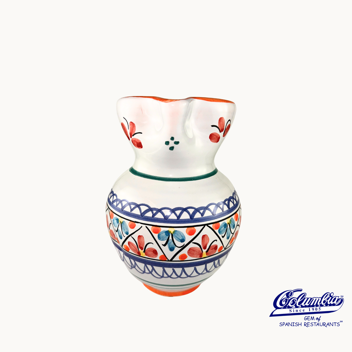 Ceramic pitcher with colorful patterns on a white background, featuring the Columbia brand.