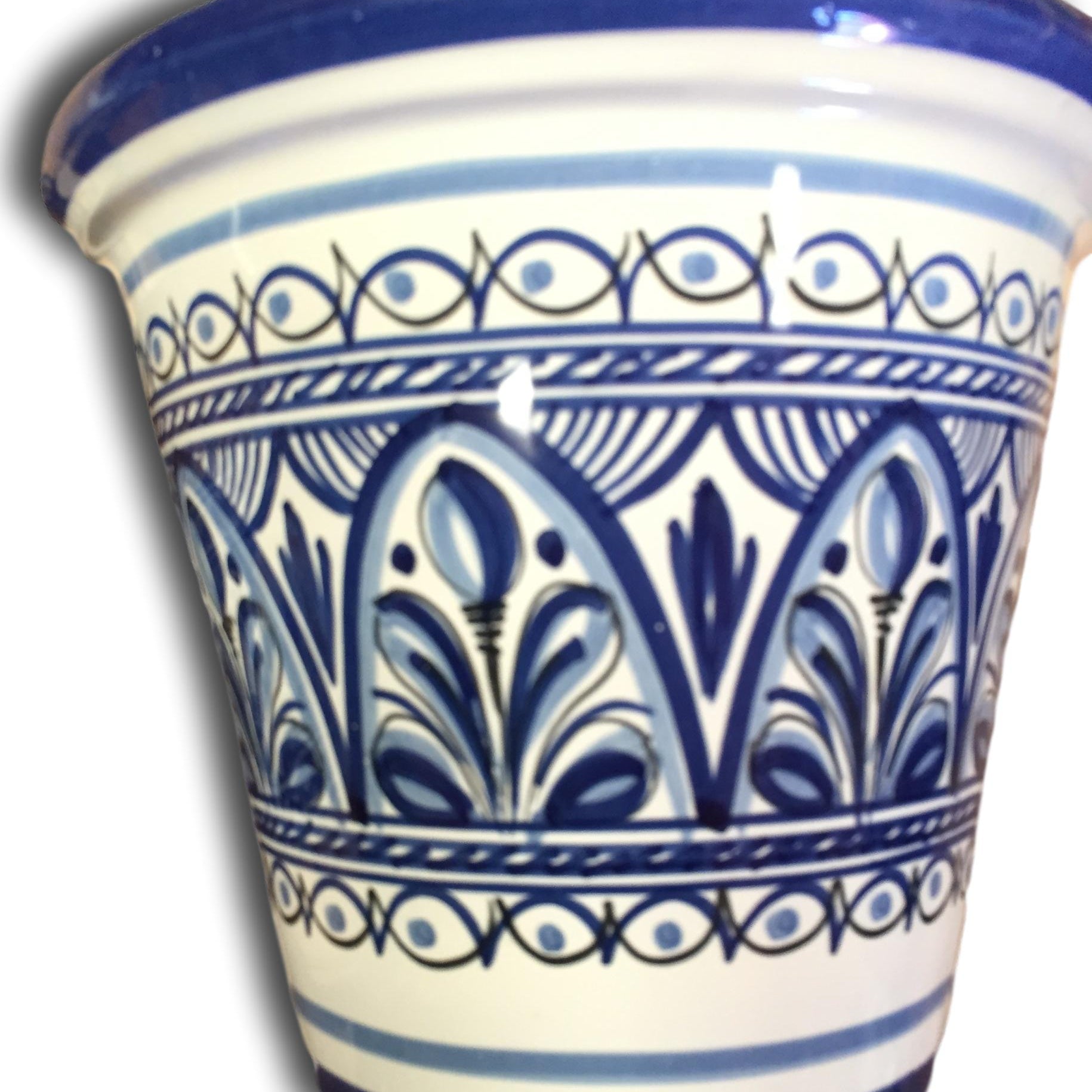 A small, hand-painted flower pot with blue and white floral patterns.