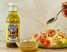 Klondike salad dressing bottle with a salad and dressing being poured on a wooden surface.
