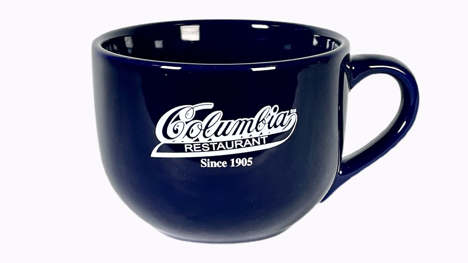 A 24 ounce navy blue ceramic mug with the Columbia logo printed in white.