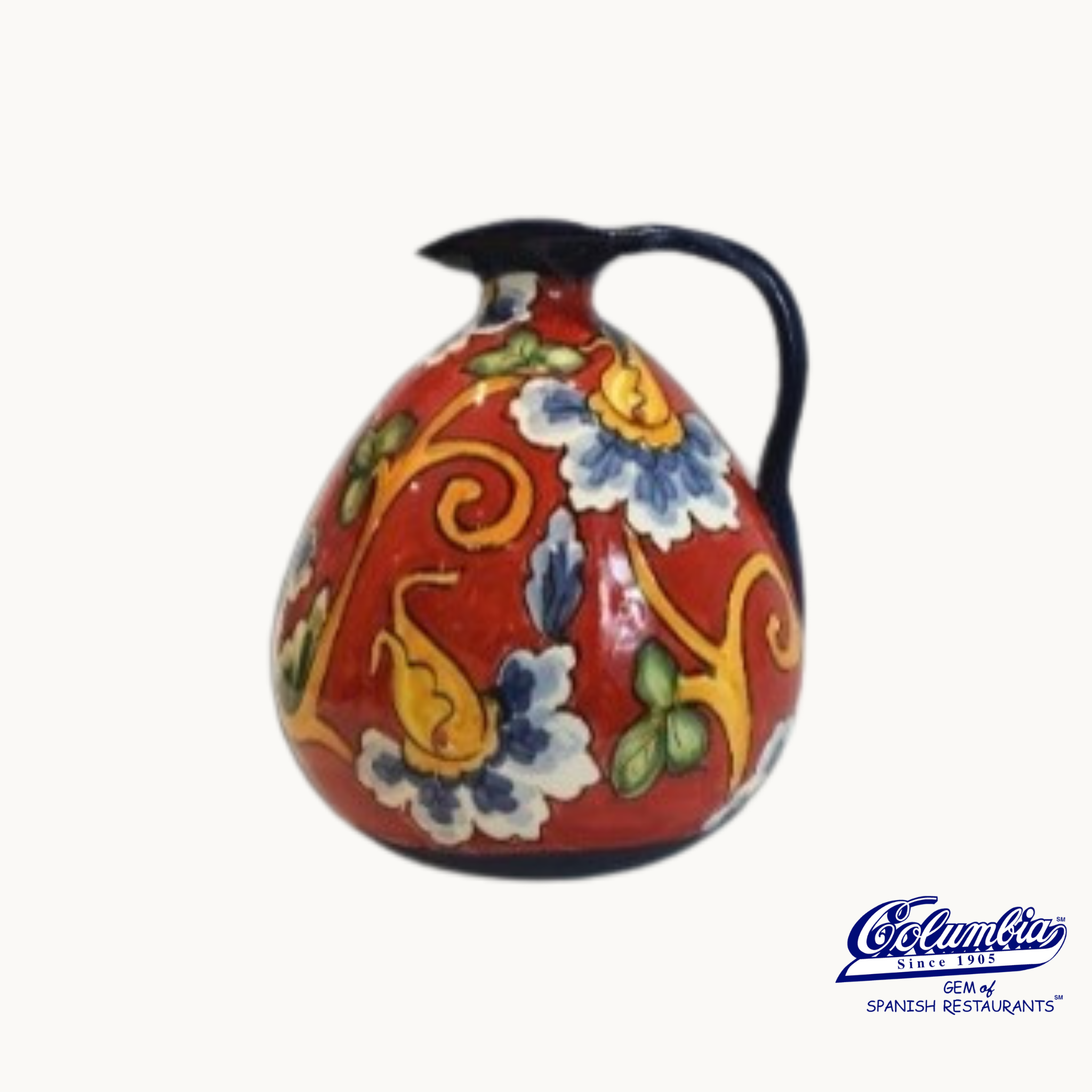 Colorful ceramic pitcher with floral patterns on a white background