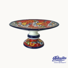 Colorful ceramic cake or fruit stand with floral designs on a white background