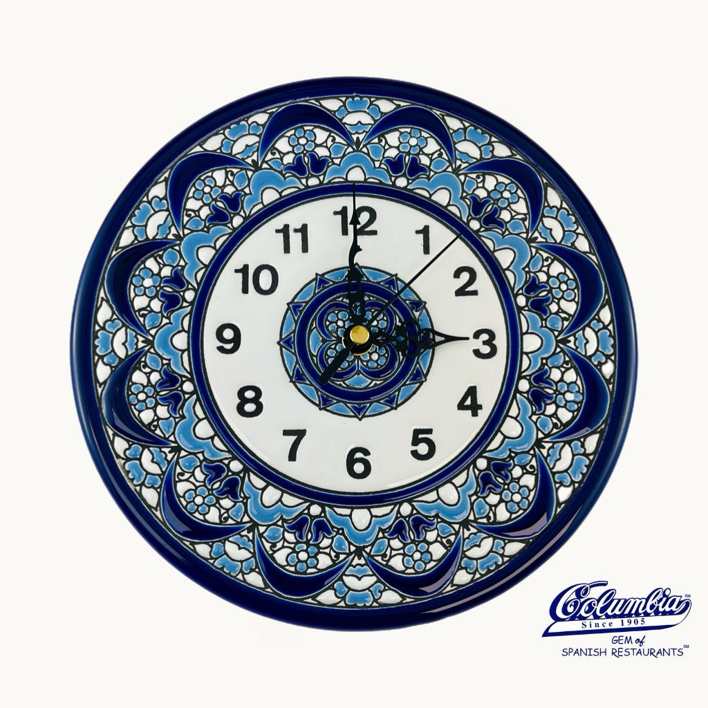 Decorative wall clock with blue floral patterns on a white background