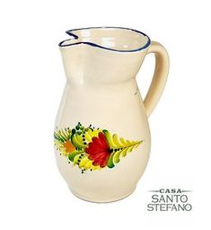 A ceramic serving pitcher with a floral design and blue trim on the rim, imported from Italy.
