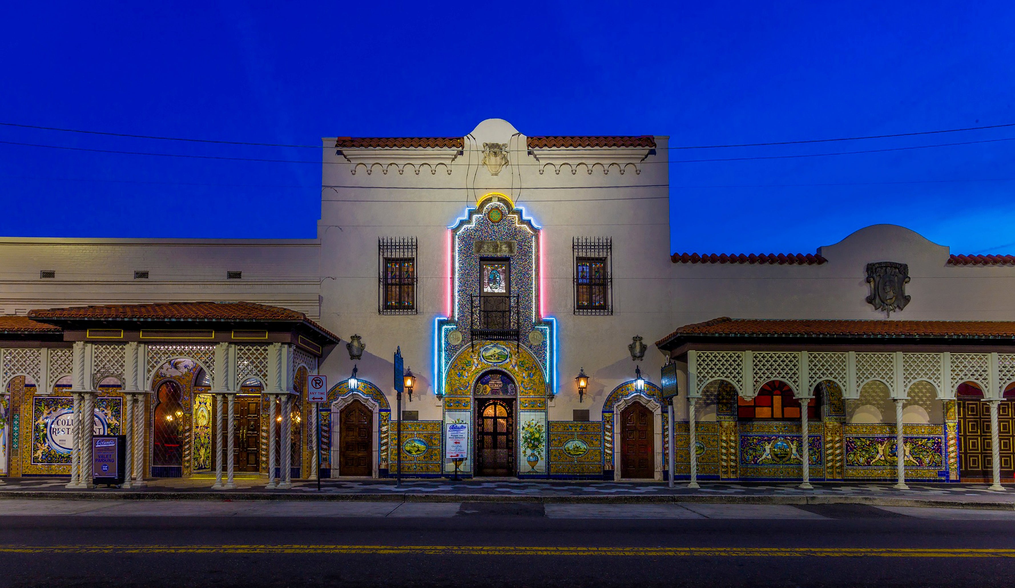 Decorative building facade with intricate designs and lighting at night