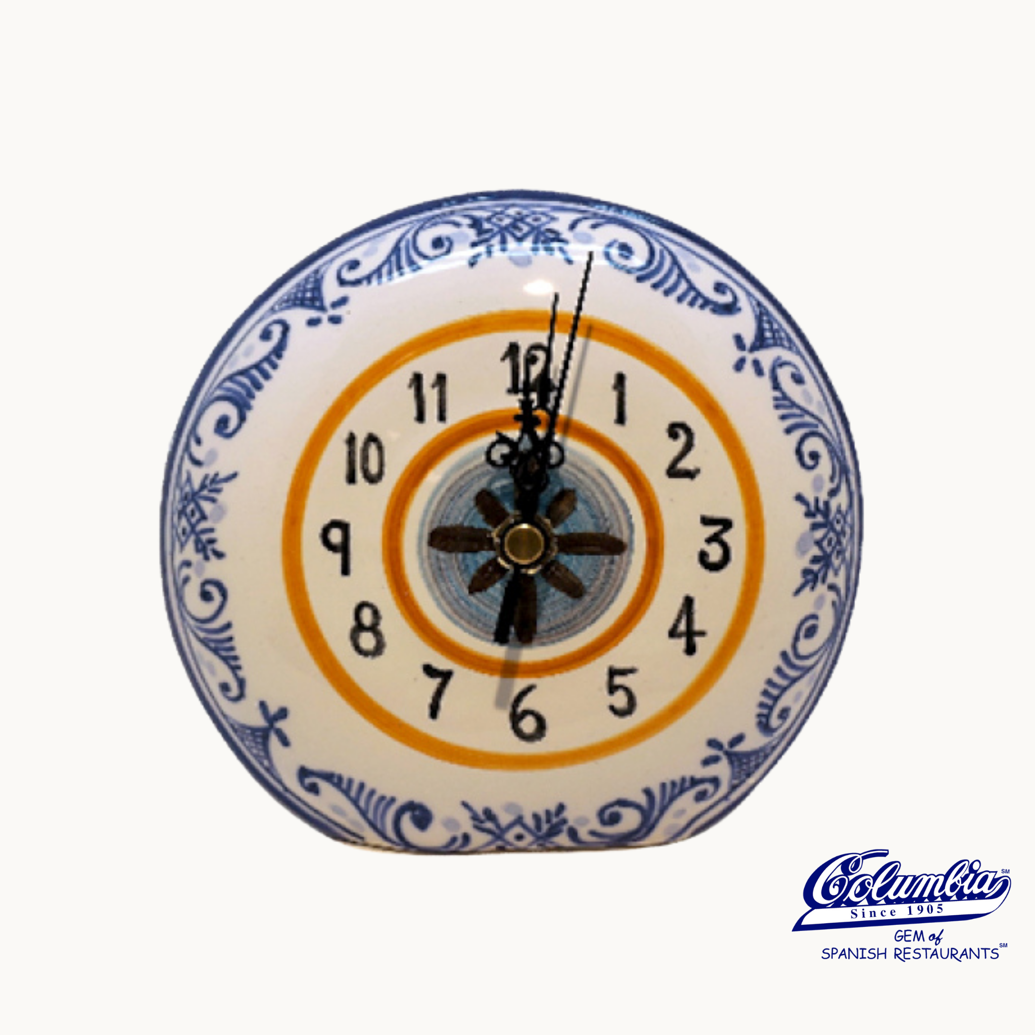 Decorative wall clock with blue and white floral patterns on a white background.