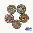 A set of five colorful ceramic coasters with ornate patterns, each 4 inches in diameter, along with the brand logo 'Cámara'.