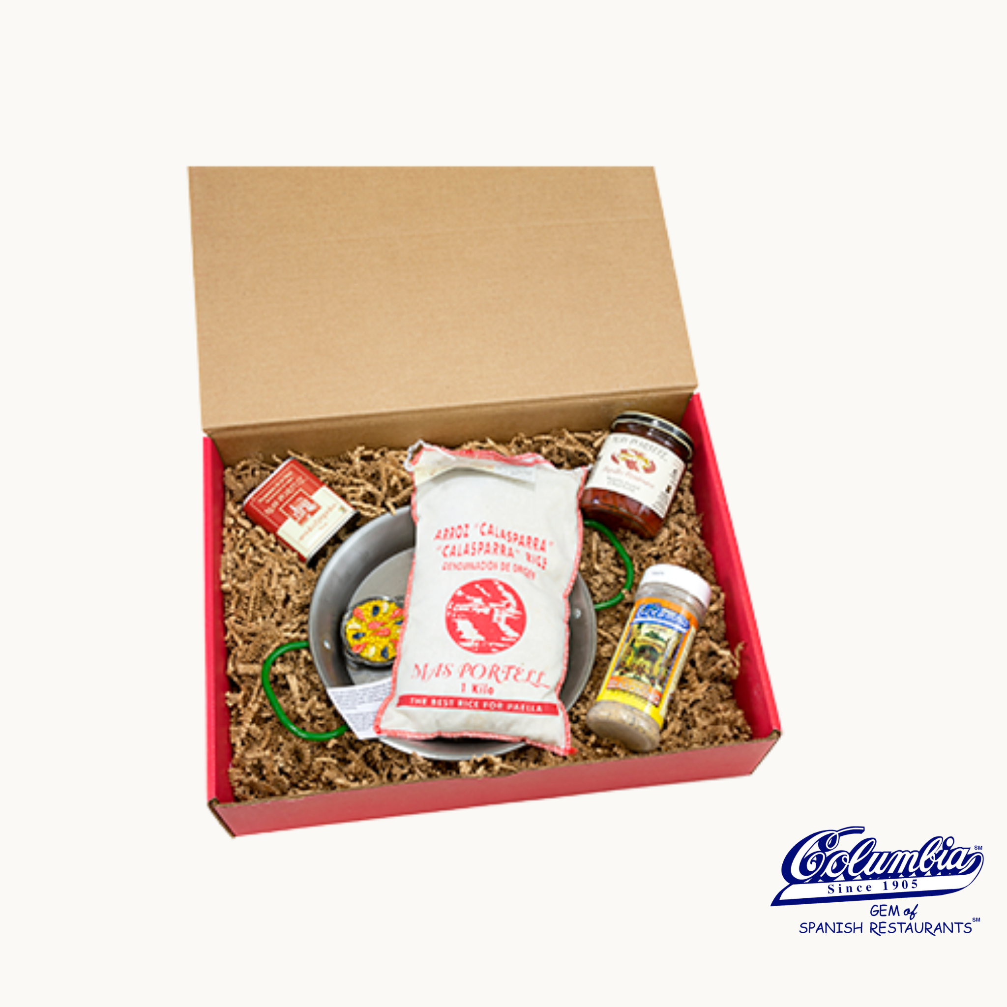 Gift box with various items including a bag labeled 'Ma Bonell' on a plain background.