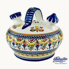 A white jar with floral designs and a blue handle on top