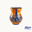 Ceramic pitcher with blue and orange design on a white background