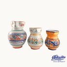 Three ceramic vases with colorful patterns on a white background, featuring the 'Columba' brand.