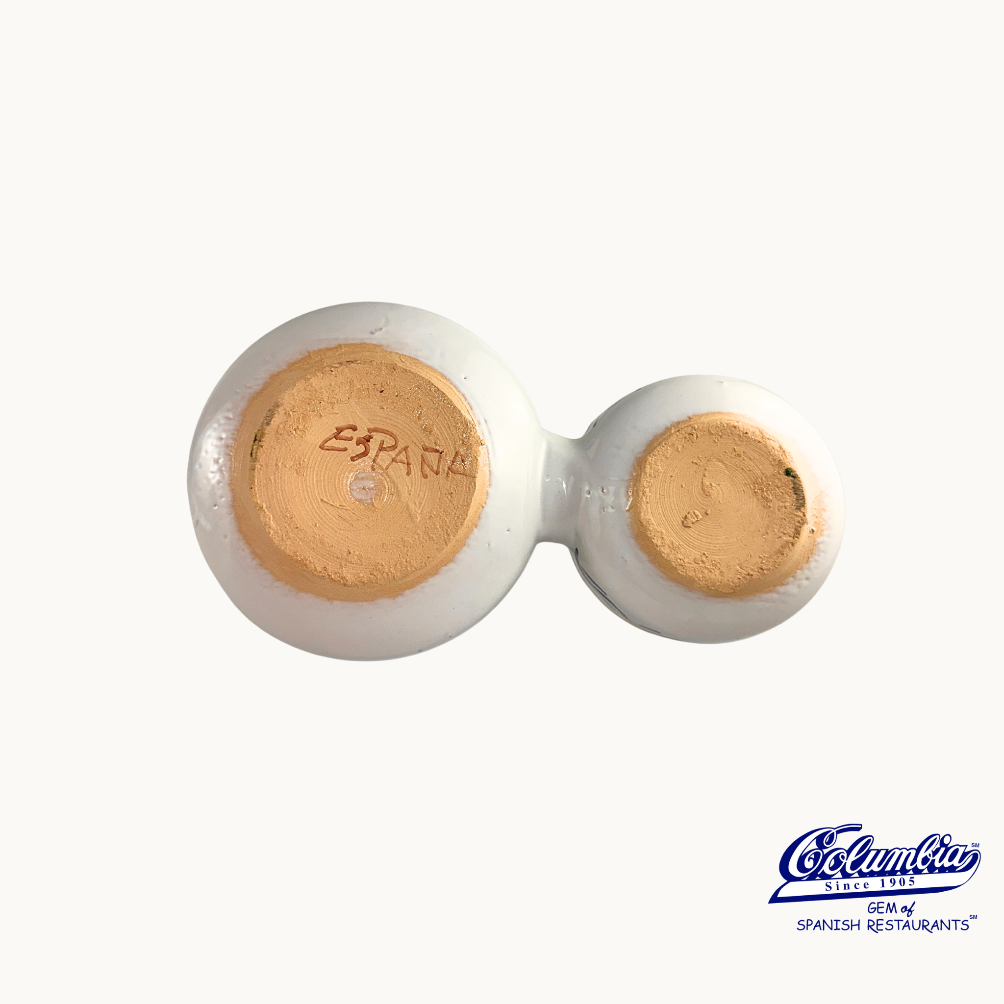 Pair of white ceramic glasses with gold interior on a white background, featuring the 'Espana' brand.