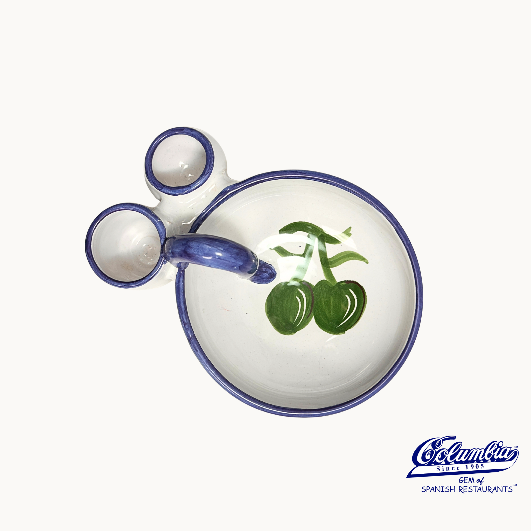 Ceramic teapot with green cherries on a white background, featuring the Columbia logo.