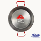 Metal paella pan with red handle and label on a white background