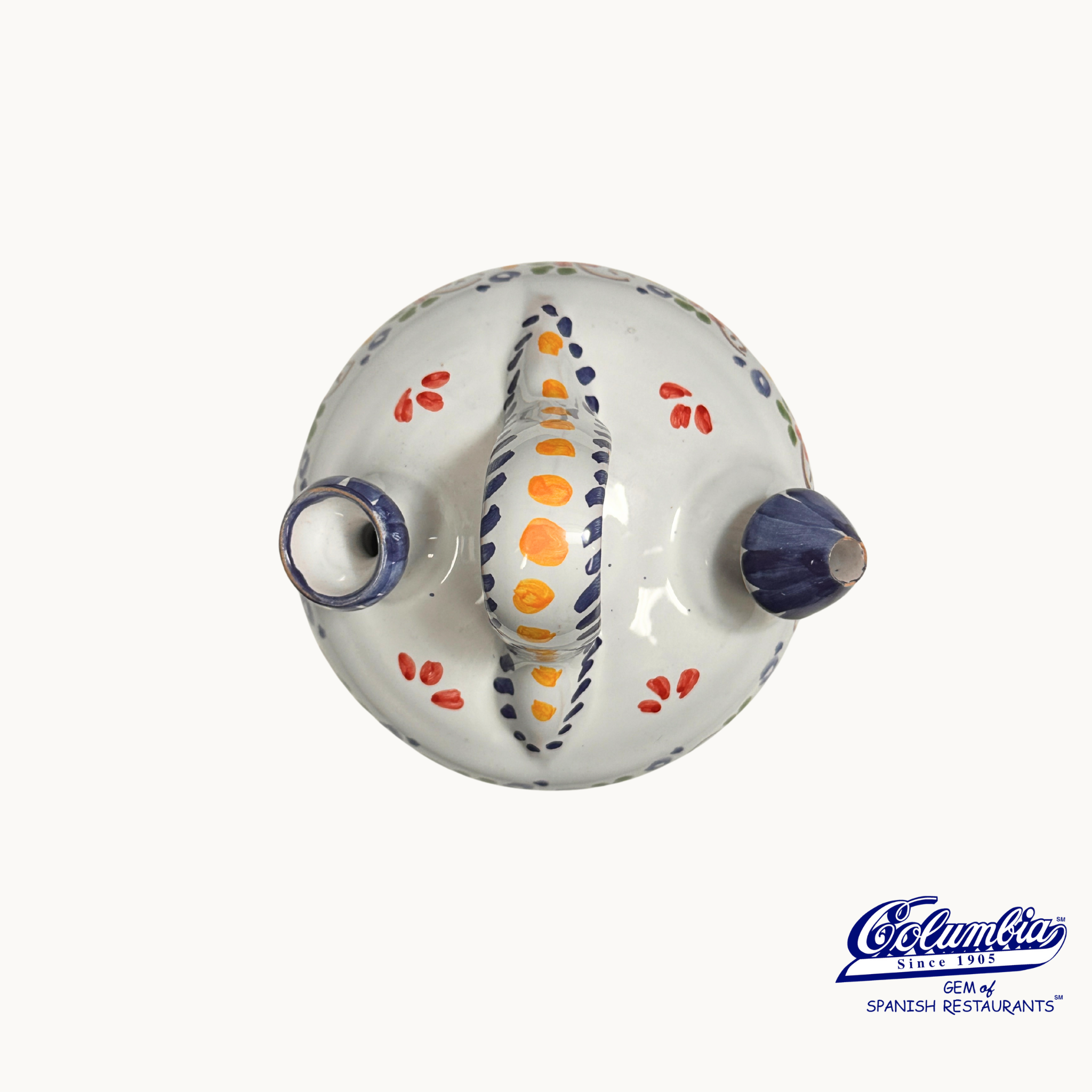 Decorative ceramic jar with colorful patterns on a white background, featuring the Columba brand.