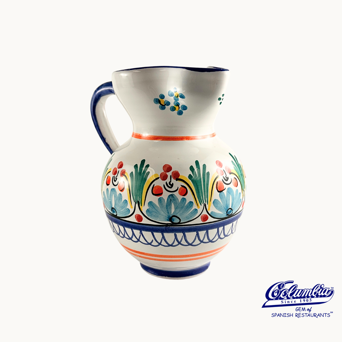 Decorative ceramic pitcher with colorful patterns on a white background, featuring the Columba brand.