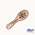 Ceramic spoon rest with colorful floral patterns on a white background top view 