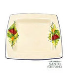 Casa Santo Stefano square ceramic plate with cream background, hand-painted floral designs in red, yellow, and green on two corners, and blue trim around the edges.