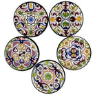 Set of five round ceramic coasters with colorful hand-painted Talavera-style patterns in floral and geometric designs.