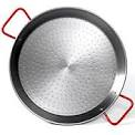 Traditional Spanish paella pan with a dimpled steel surface and two red side handles
